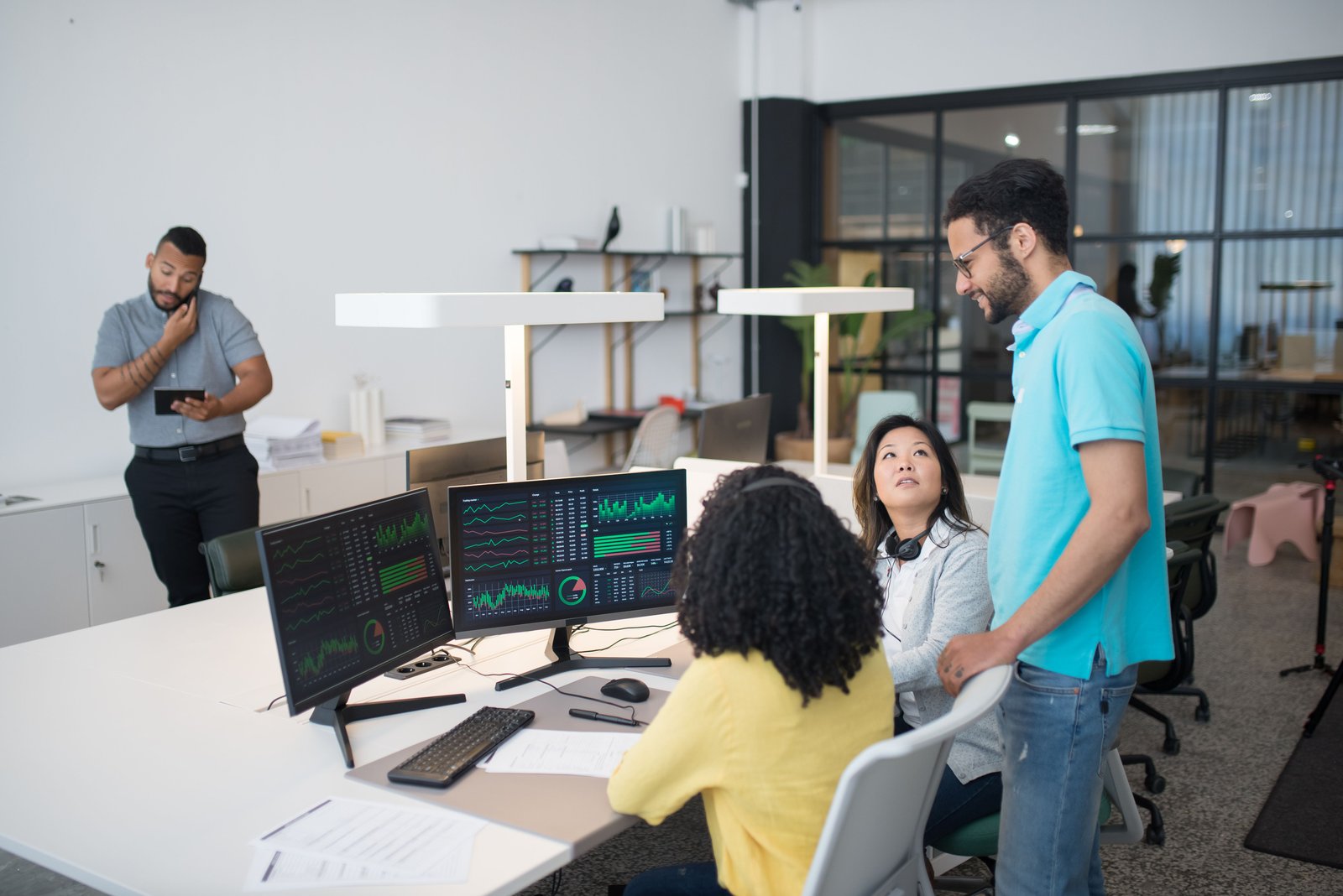Office team engaged with financial and business data at a modern workspace