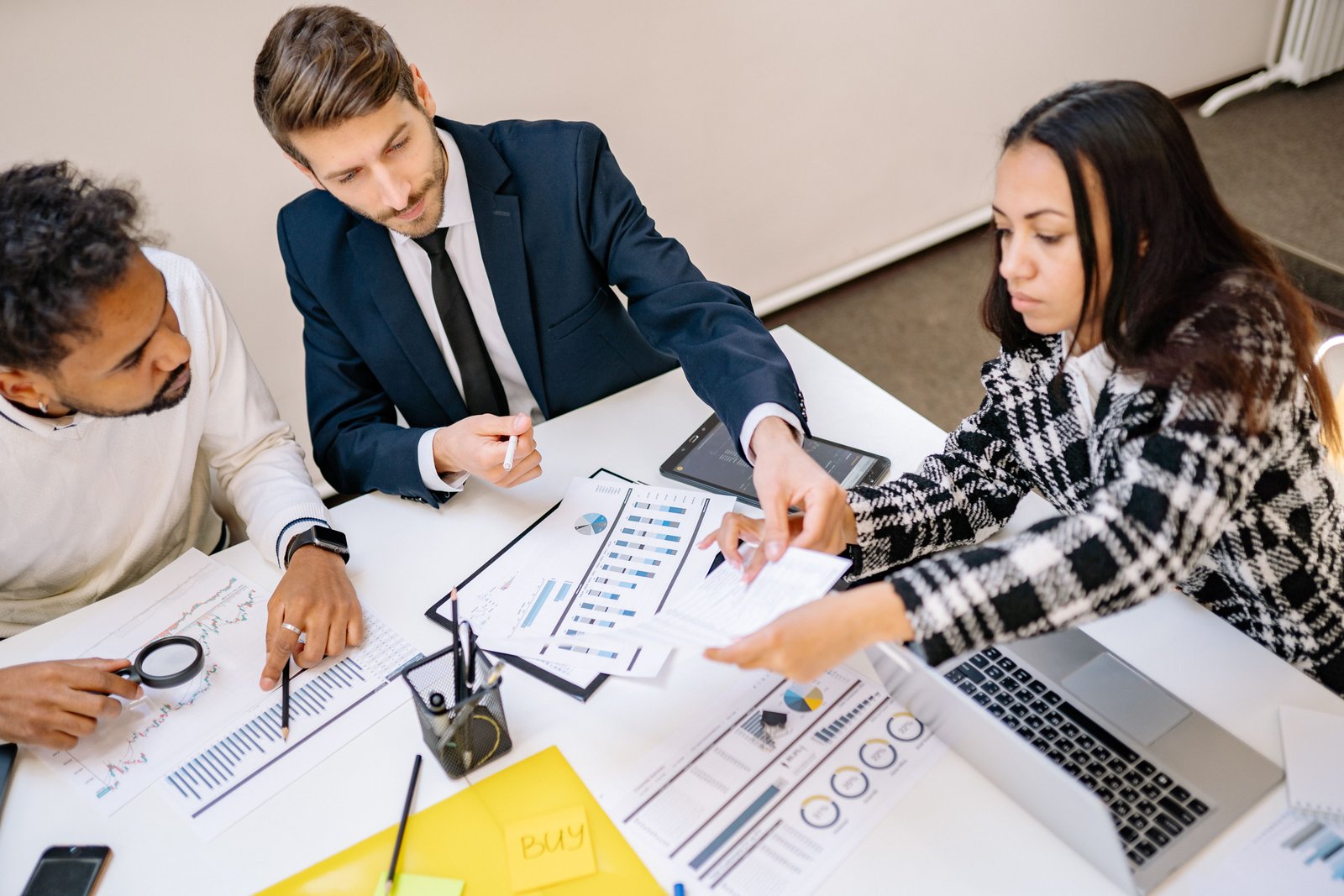 Business leaders reviewing a growth and innovation strategy roadmap with charts and documents