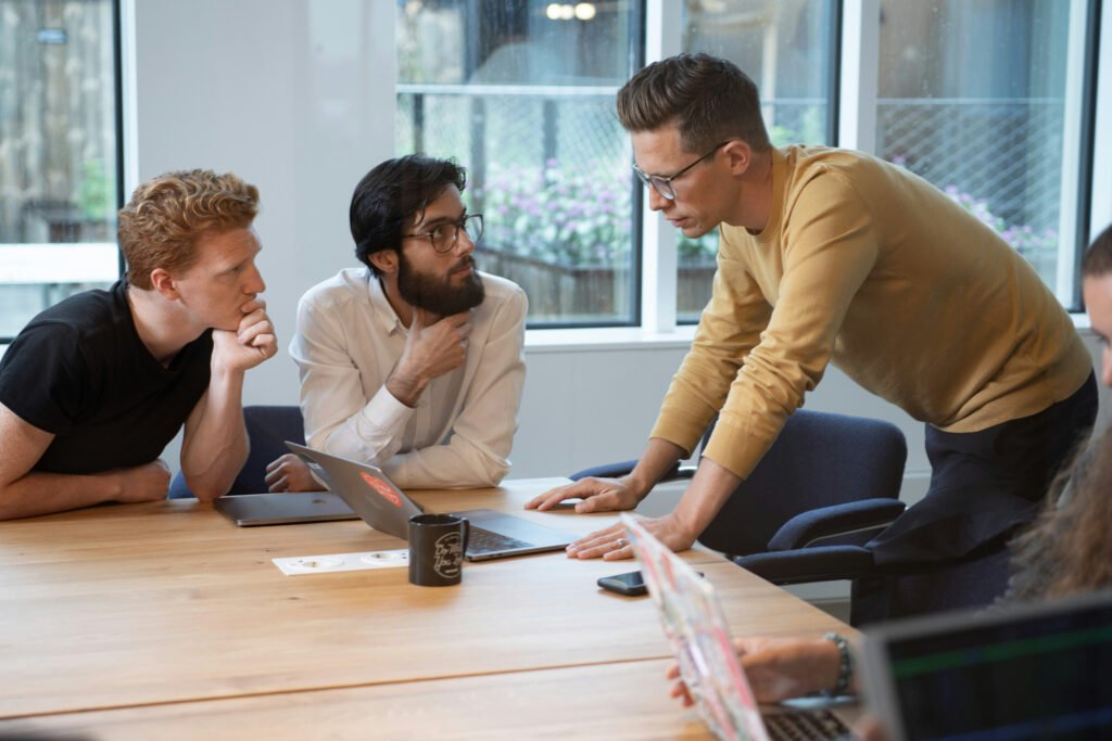 Three colleagues in a strategy discussion around a conference table